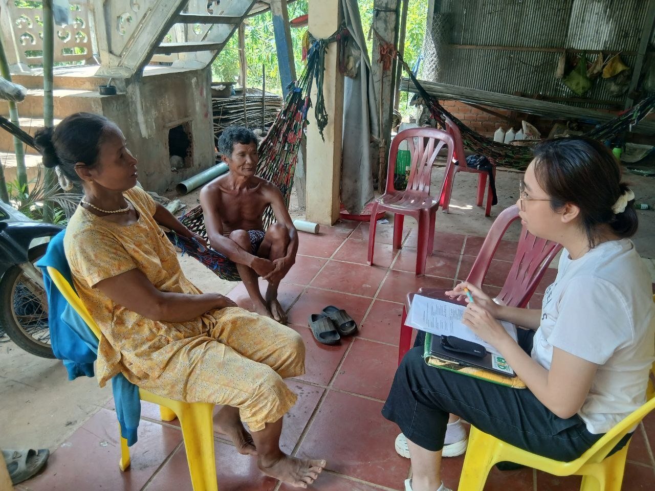 A researcher listens to a farming household during a GeNA monitoring interview in Kampong Cham