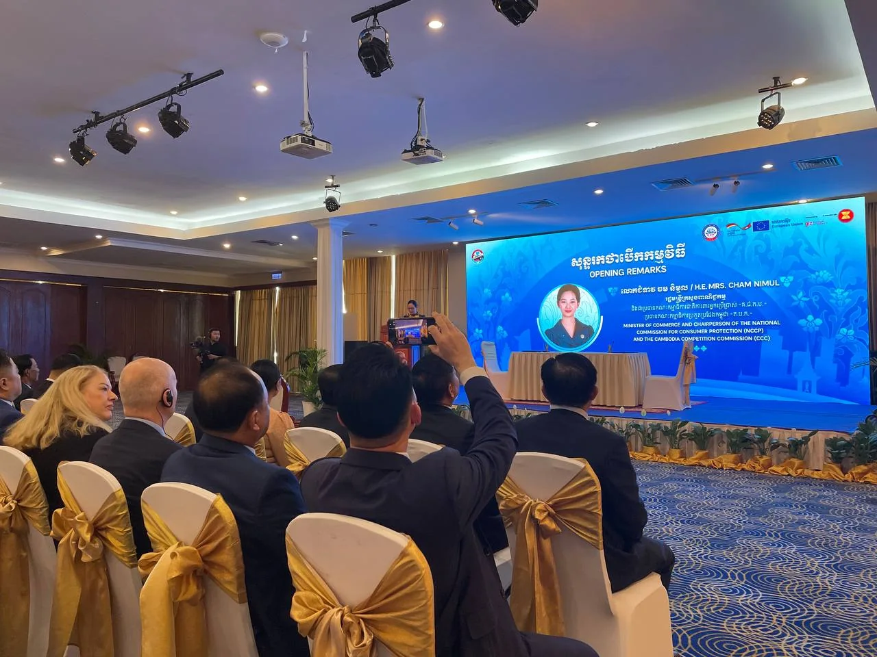 Audience and opening-remarks stage at a consumer-protection workshop