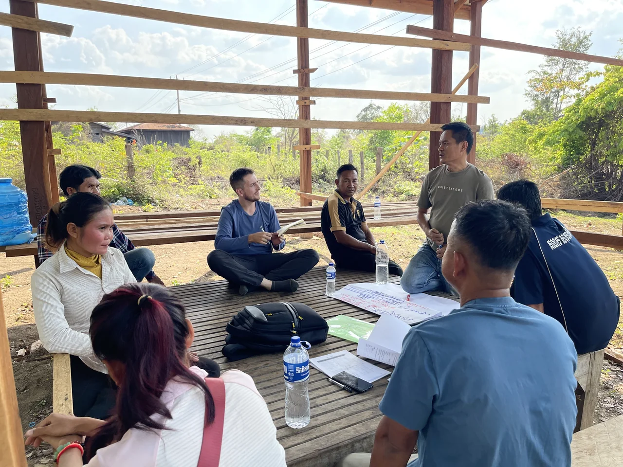 Farmer-organisation participants discuss priorities in an open meeting shelter