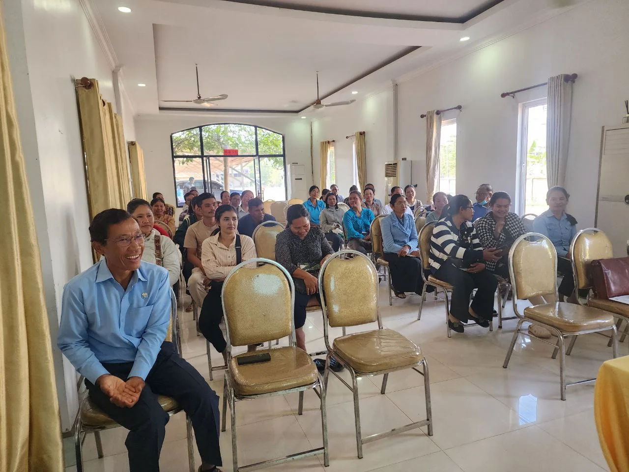 Savings-group meeting participants listen during an annual planning discussion